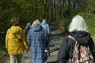 a group of people walking down a dirt road