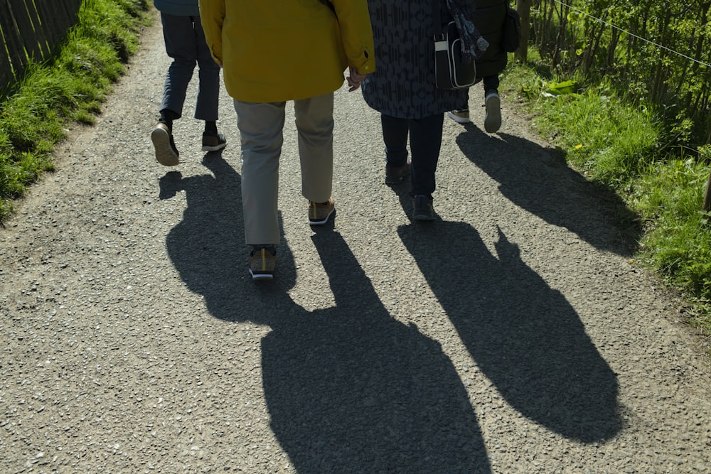 a group of people walking down a dirt road