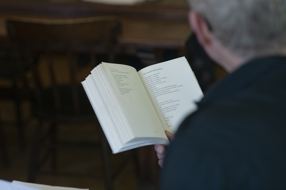 a man reading a book in a library