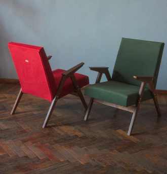 a couple of chairs sitting on top of a hard wood floor