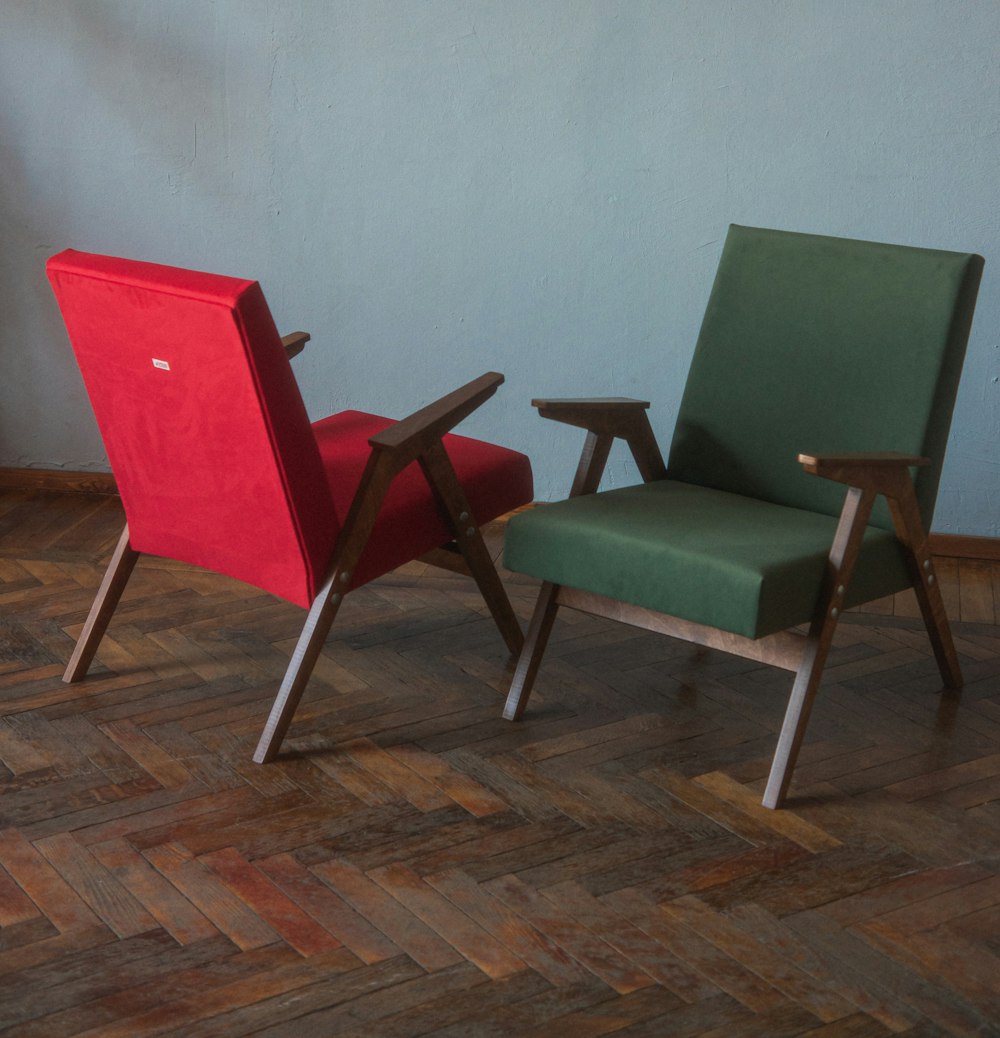 a couple of chairs sitting on top of a hard wood floor