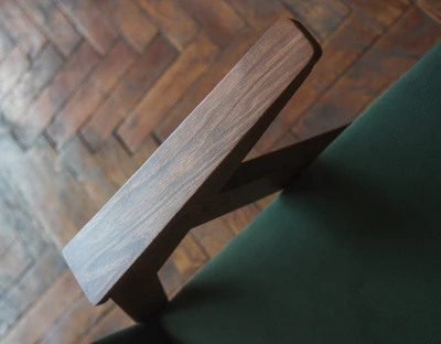 Close-up of fabric texture and wooden armrest of classic sofa