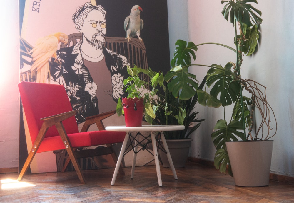 a red chair and a white table in a room