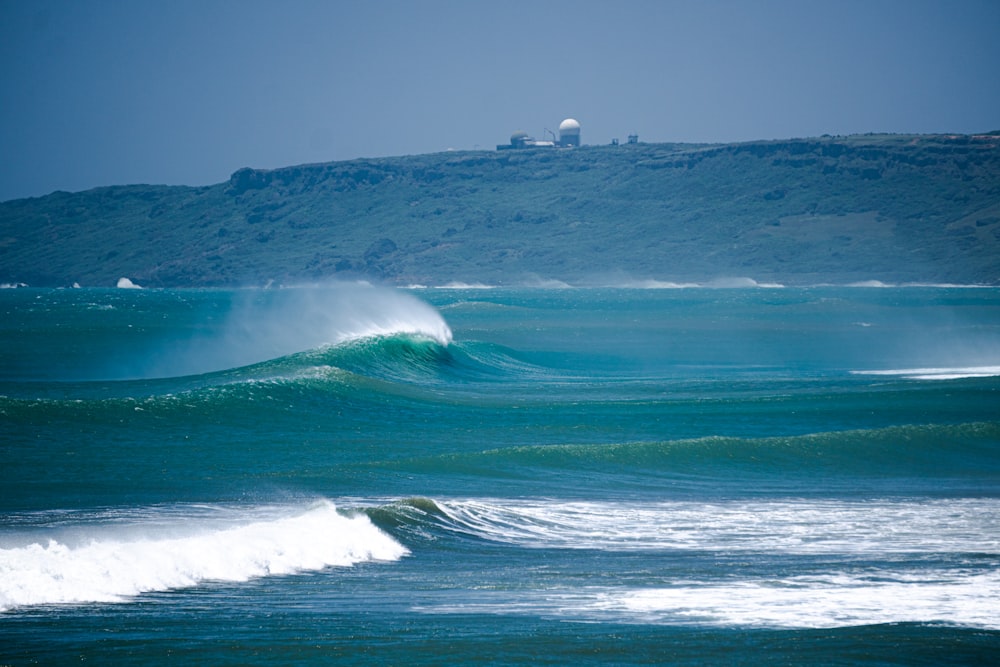 a person riding a wave on top of a surfboard