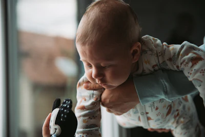 a baby playing with a remote control
