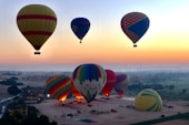 a group of hot air balloons flying in the sky