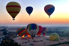 a group of hot air balloons flying in the sky
