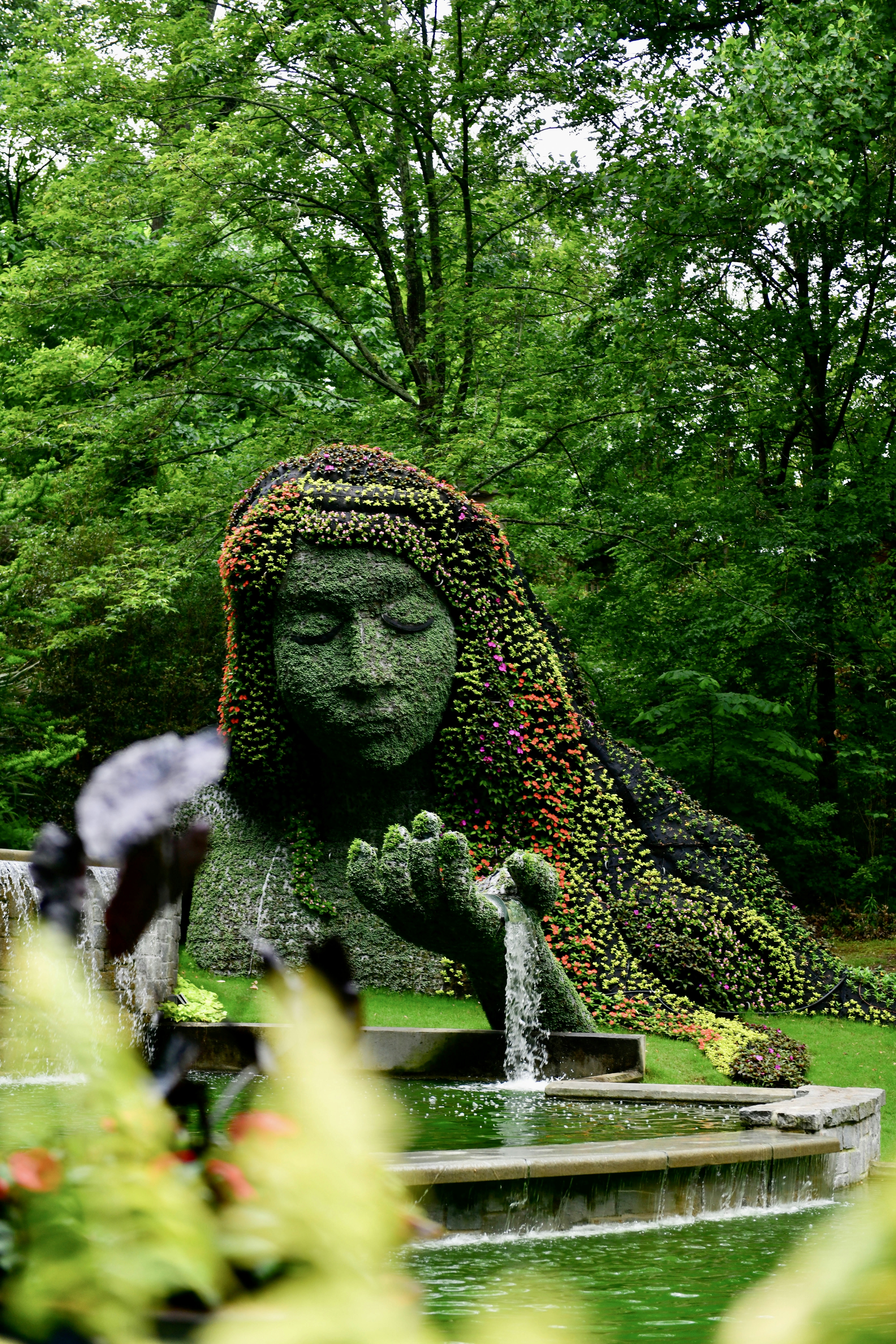 a statue of a woman covered in flowers