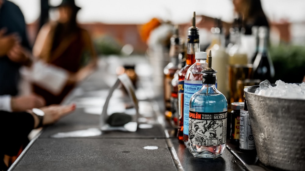 bottles of alcohol are lined up on a bar