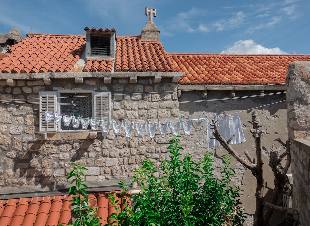 a stone building with a red tiled roof