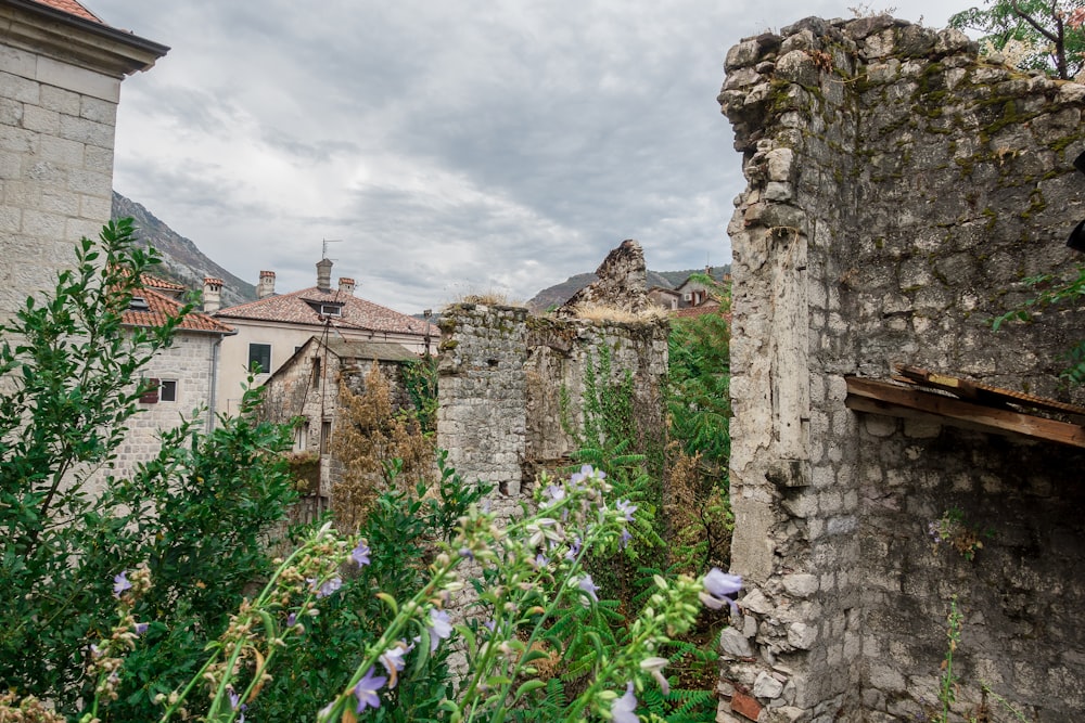 a stone building with a bunch of flowers growing out of it