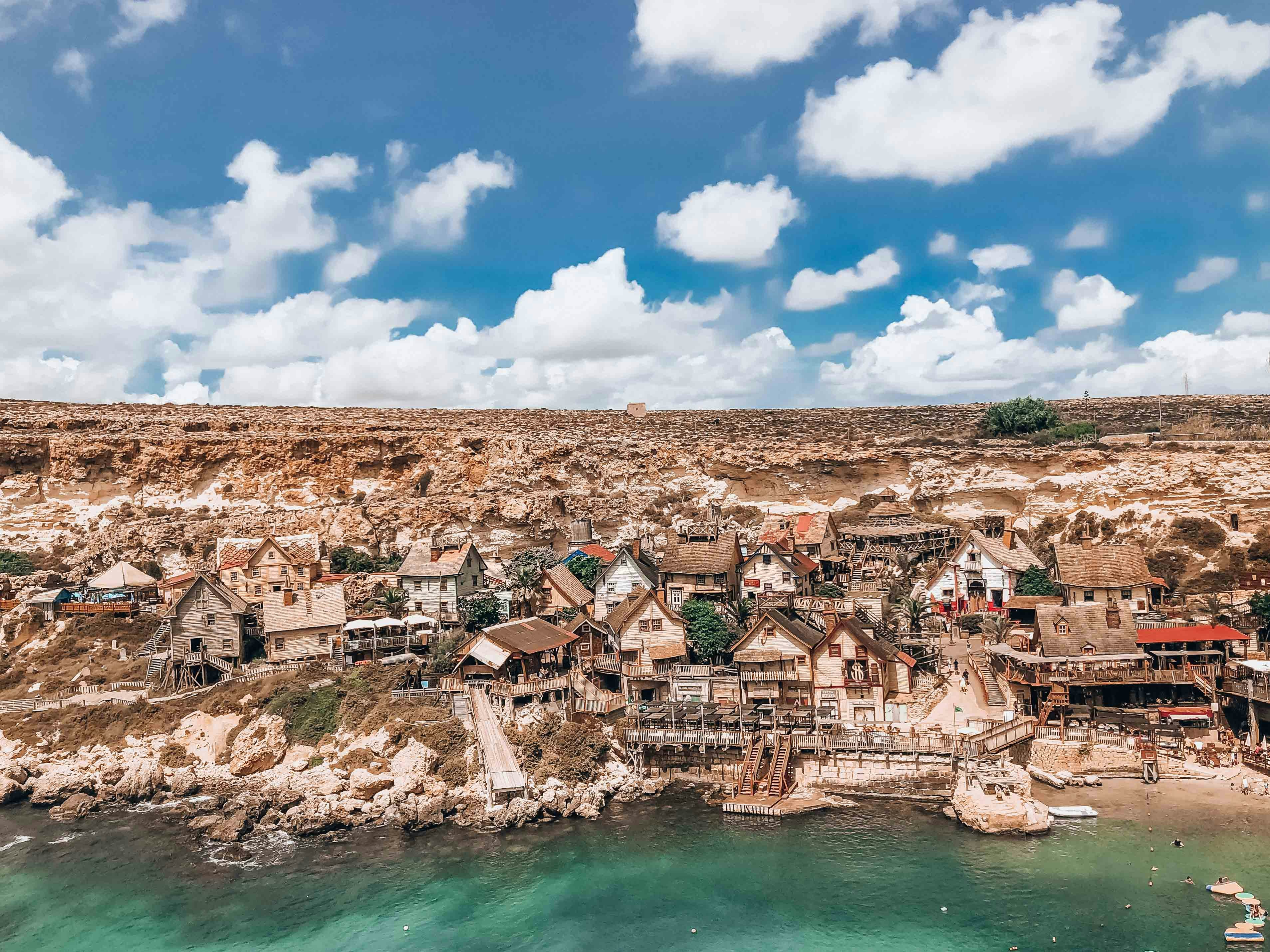 an aerial view of a village on a beach