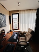 Modern home office with sleek desk, ergonomic chair, and natural light.
