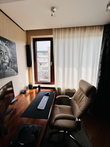 A sleek, modern home office setup featuring a stylish desk with a comfortable ergonomic chair bathed in natural light.
