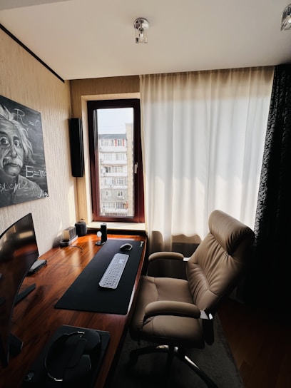A sleek, modern home office setup featuring a stylish desk with a comfortable ergonomic chair bathed in natural light.
