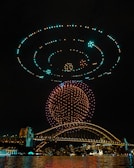 A synchronized drone light show illuminating the night sky.