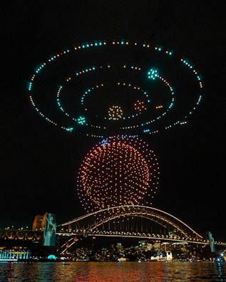 A synchronized drone light show illuminating the night sky.
