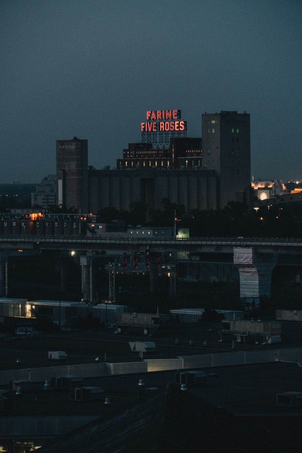 a view of a city at night with a neon sign