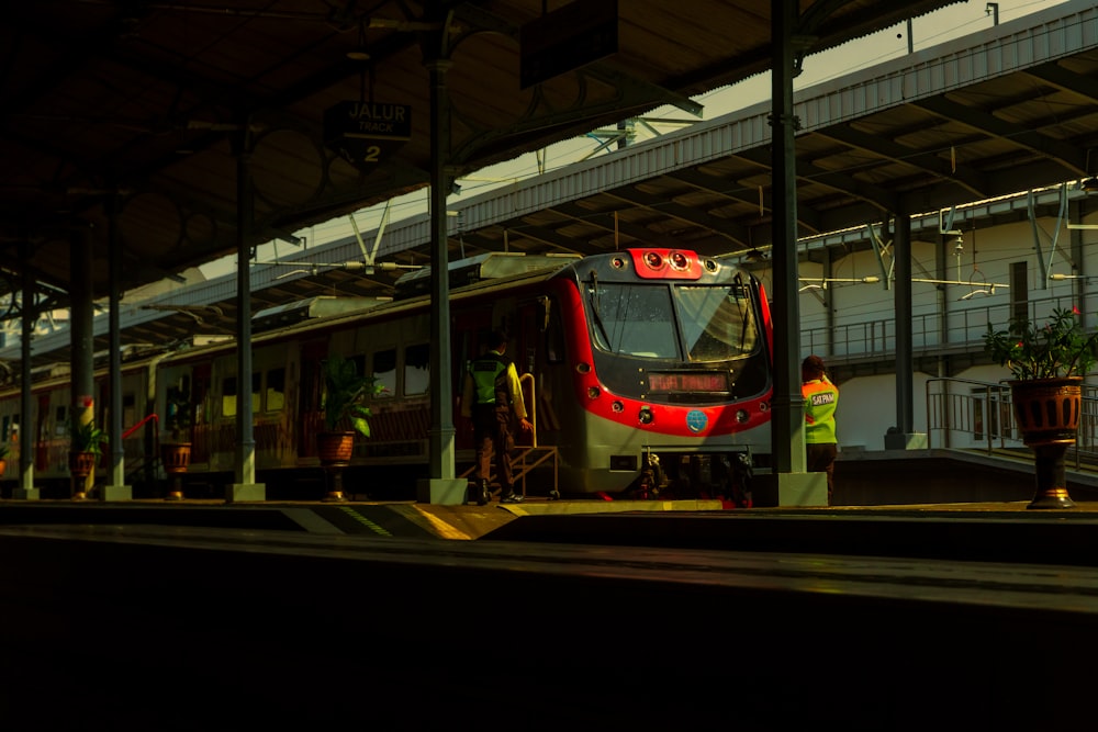 a red and white train at a train station