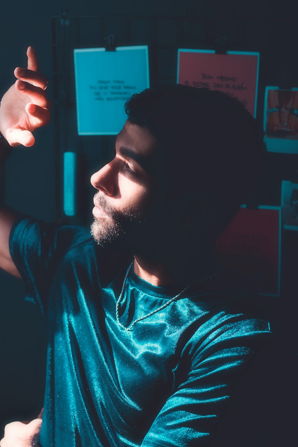 a man in a blue shirt pointing at something