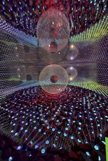 A mesmerizing, abstract scene featuring a large spherical structure set within a vast grid of multicolored lights and geometric patterns. The interplay of blue, red, and green hues creates a hypnotic and futuristic atmosphere.