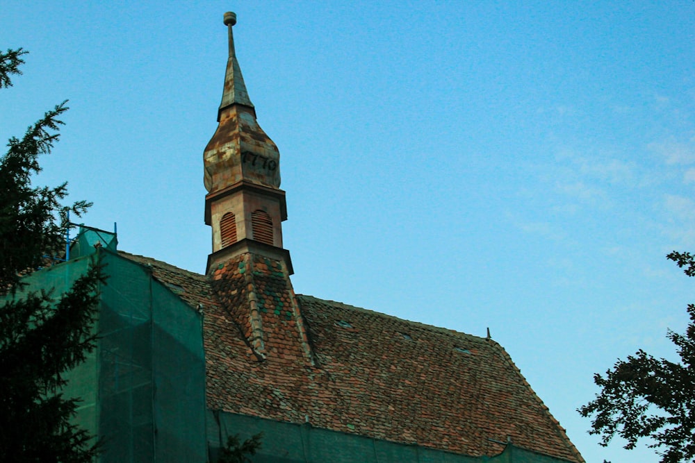 an old building with a steeple and a clock on it