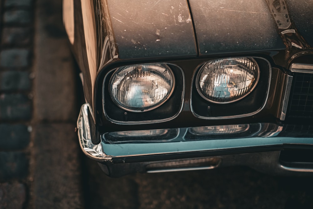 a close up of a car headlight on a street