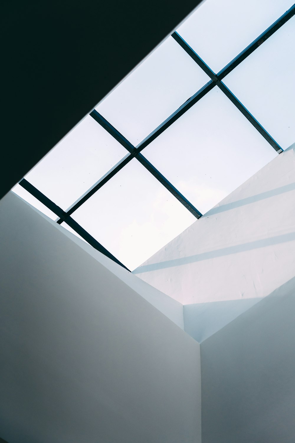 a white room with a skylight above it