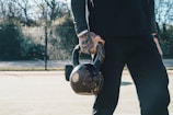 a man holding a kettle on a tennis court