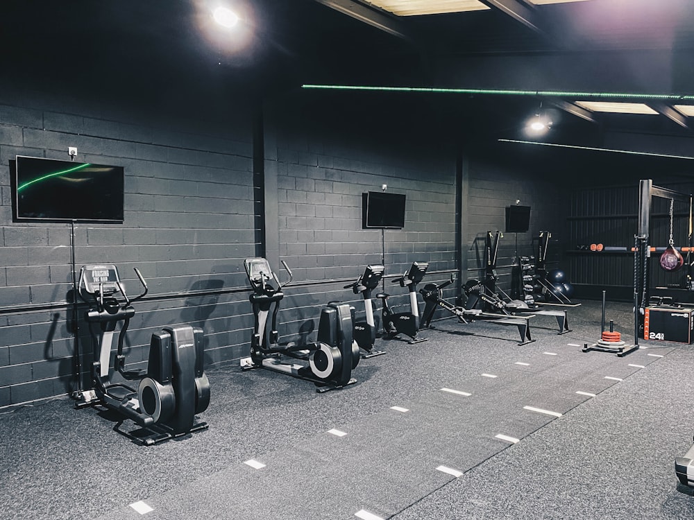 a gym with a row of exercise machines