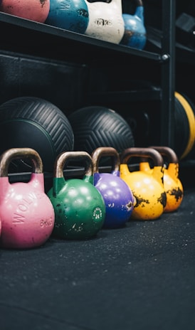 a row of colorful kettles in a gym