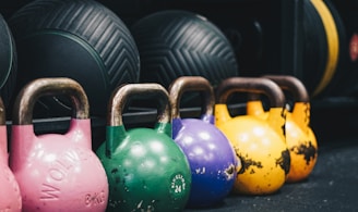 a row of colorful kettles in a gym