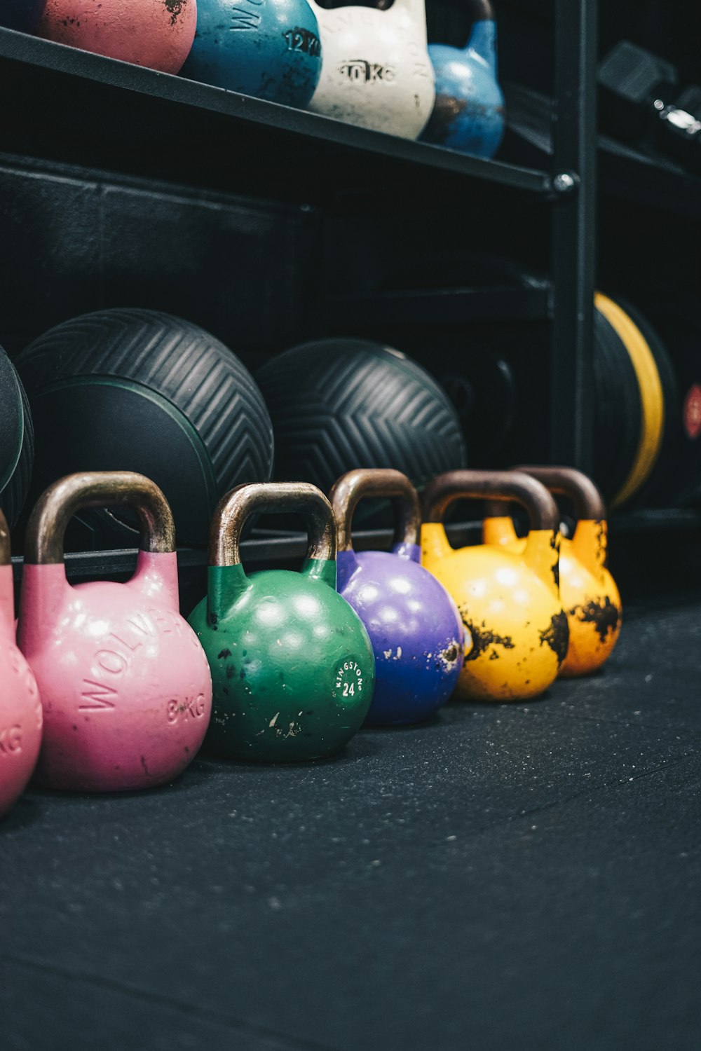 a row of colorful kettles in a gym