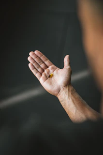 a man holding his hand out with a ring on it