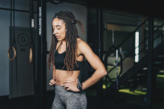a woman with dreadlocks standing in a gym