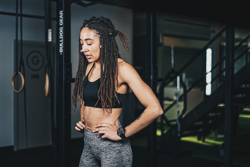 a woman with dreadlocks standing in a gym