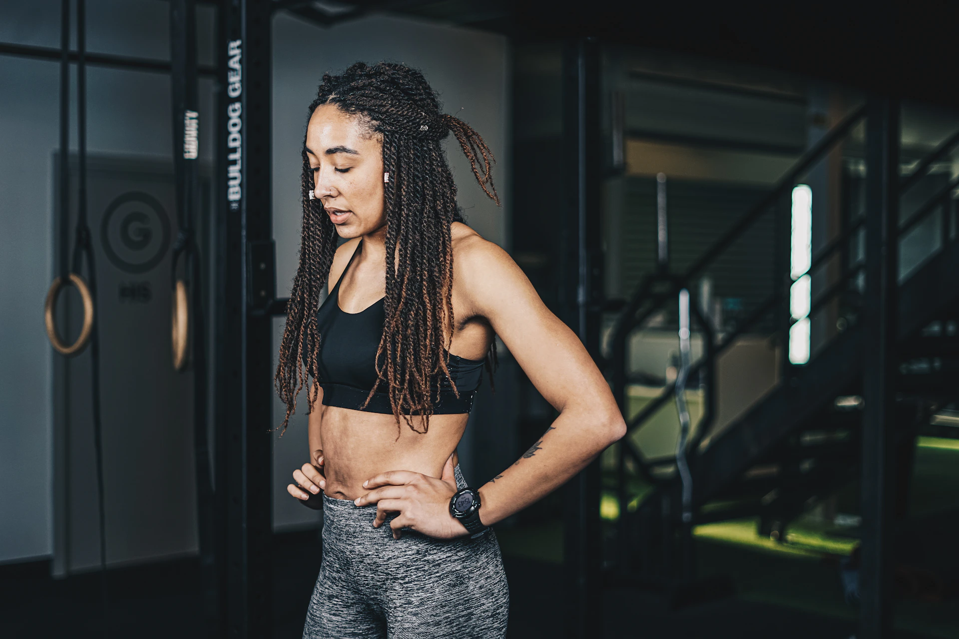 a woman with dreadlocks standing in a gym