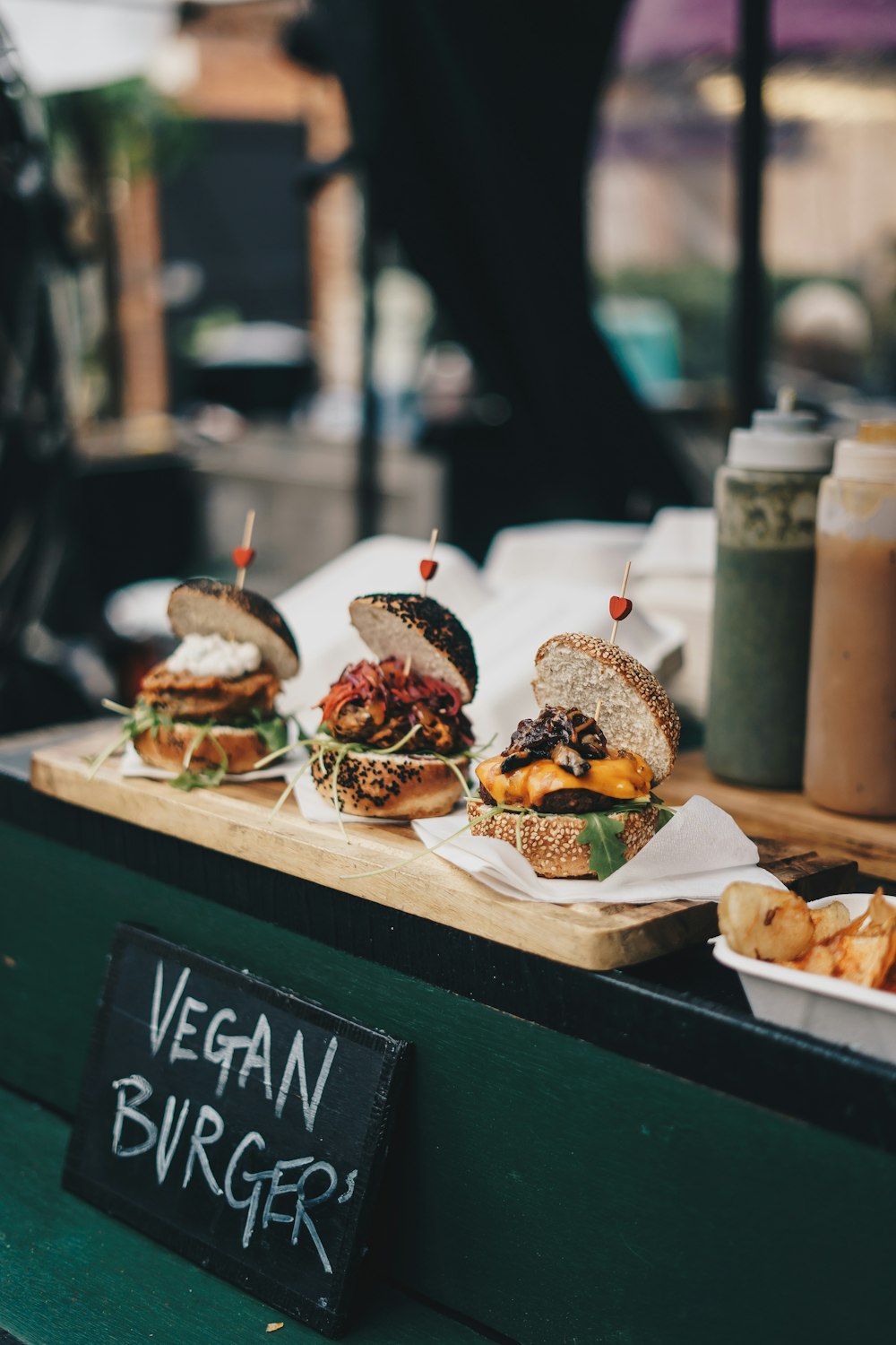 a table topped with lots of different types of burgers