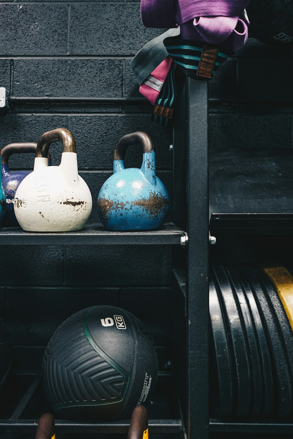 a rack with kettles, kettles, and a ball on it