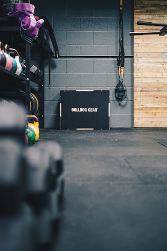 Fitness accessories including resistance bands and water bottles on a gym floor.