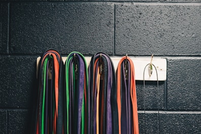 A set of colorful resistance bands neatly arranged on a gym floor.