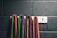 A close-up of colorful resistance bands neatly arranged on a wooden floor.