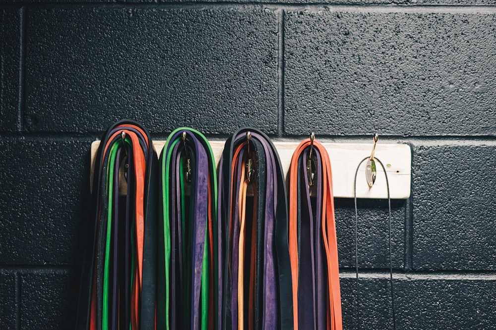 a bunch of colorful cords hanging on a wall