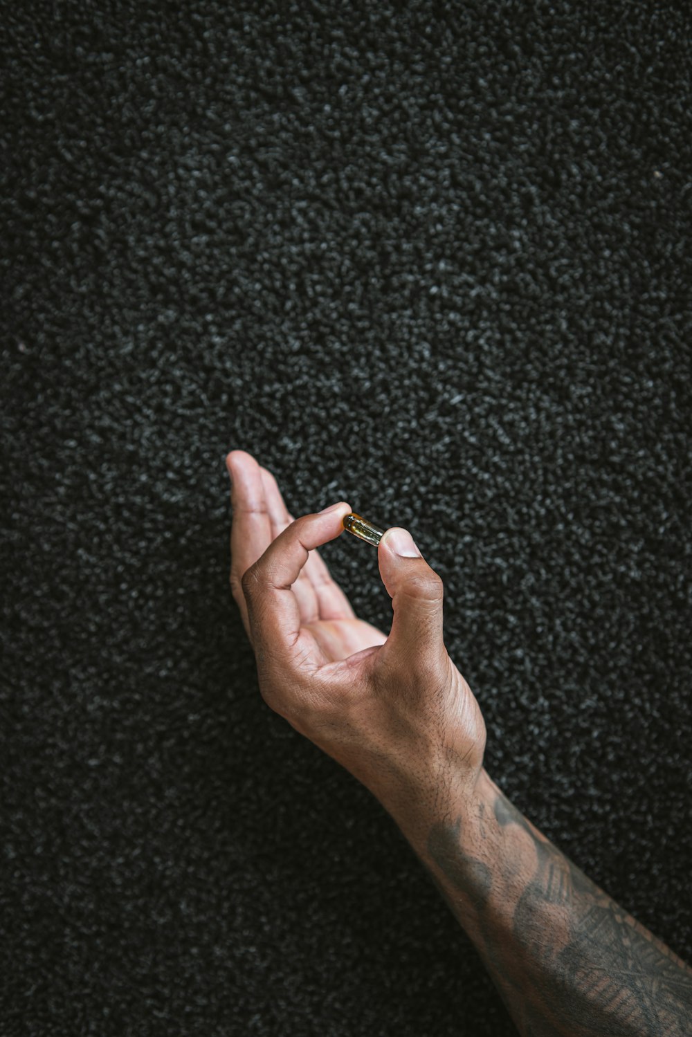 a person holding a cigarette in their hand