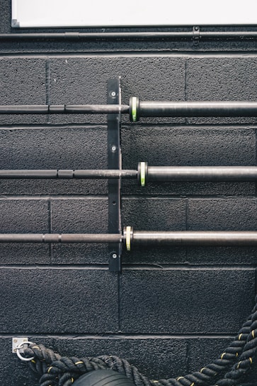 Close-up of Ritfit power rack safety pins and adjustable hooks showing solid build.
