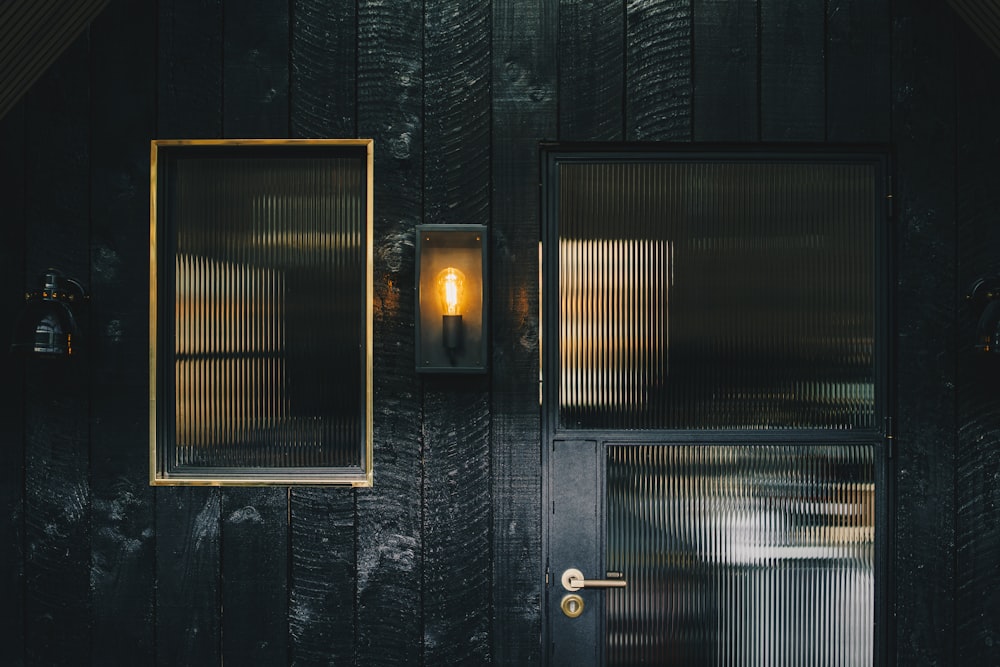 a black door with a yellow light on it