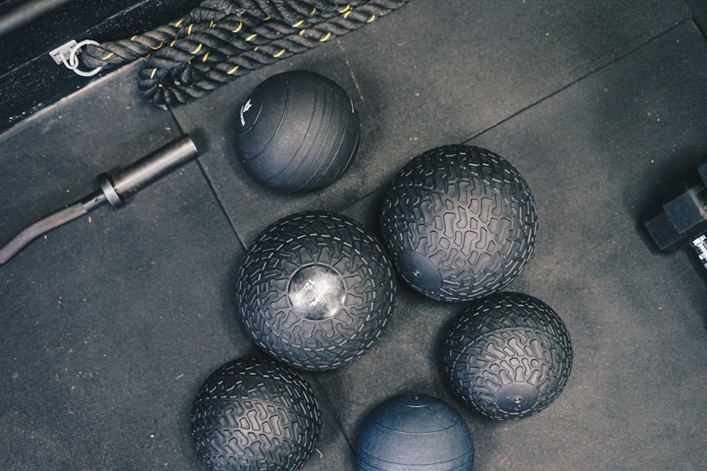 a group of balls sitting on top of a gym floor