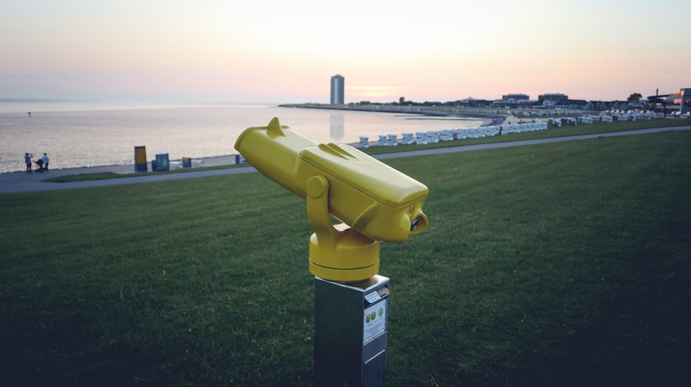 a pair of yellow binoculars sitting on top of a green field