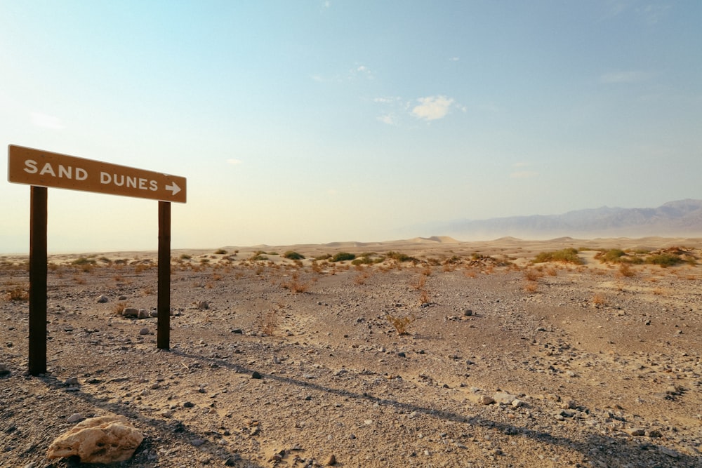 a road sign in the middle of a desert