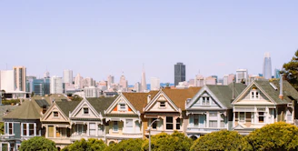 a row of houses with a city in the background